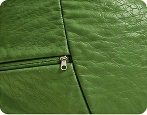 Detalhe do tecido Corano verde e do zíper do puff com proteção